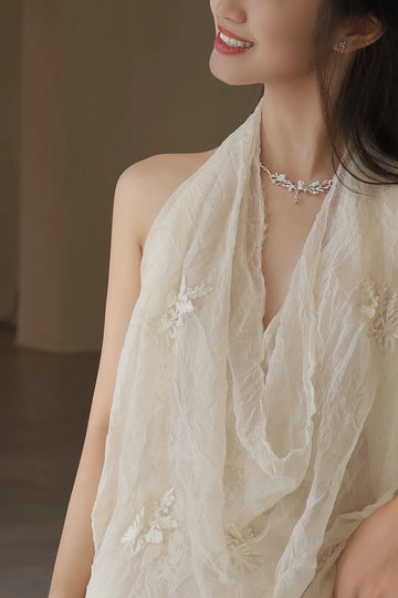 Woman wearing an AOKINSIDE botanical sterling silver choker necklace with sculpted vine and floral details.