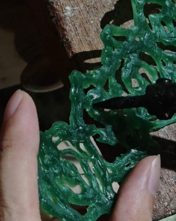 Artisan hand-carving an organic wax model for AOKINSIDE nature-inspired jewelry using the traditional lost-wax process.